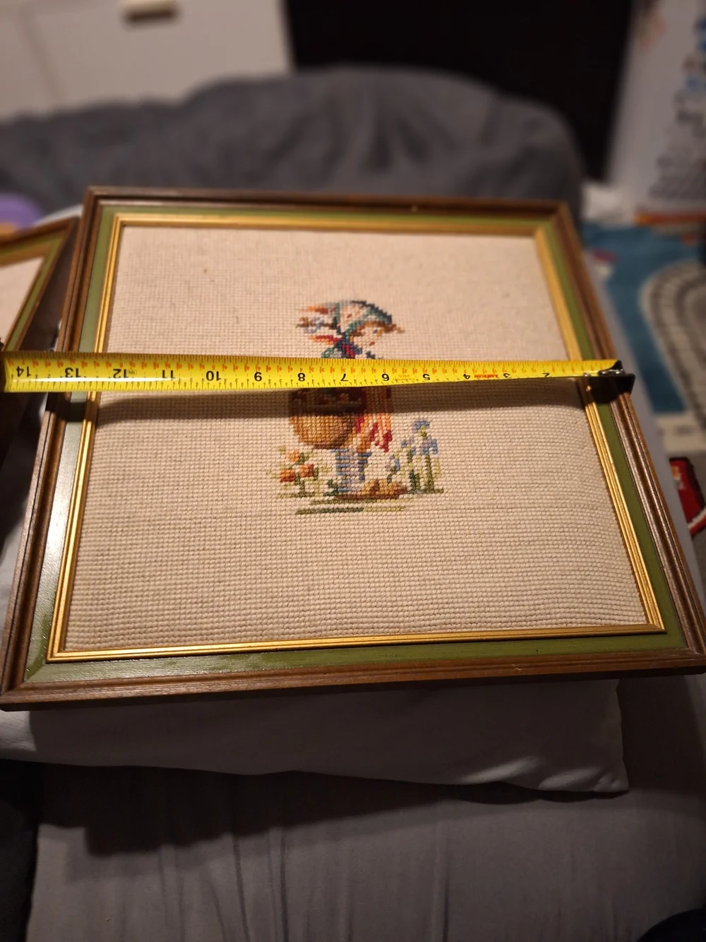 a pair of vintage Hummel framed needlepoint pictures featuring a boy a Girl